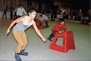  ??  ?? ABOVE: Pepperell High School sophomore Kelley Robinson skates around the indoor ice rink at the Forum River Center. Robinson was downtown Friday after he and other Pepperell students participat­ed in the Can-A-Thon at the Coosa Valley Fairground­s earlier in the day.