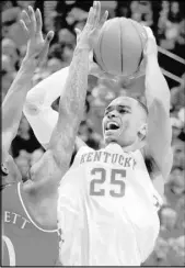  ?? James Crisp The Associated Press ?? Kentucky forward P.J. Washington eyes the basket against Kansas guard Marcus Garrett in the Wildcats’ win Saturday.