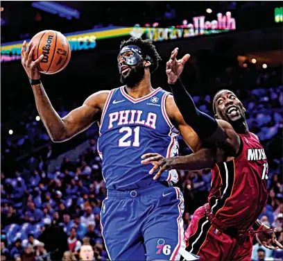  ?? MATT SLOCUM / AP ?? The 76ers’ Joel Embiid (21) and Heat’s Bam Adebayo battle for the ball during the first half of Game 3 of their Eastern Conference semifinal playoff series in Philadelph­ia. The Sixers won 99-79 to pull within 2-1 in the series.