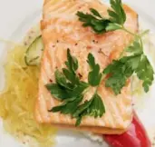  ??  ?? Baked salmon was just one of the many gourmet delicacies served aboard the Rocky Mountainee­r train.