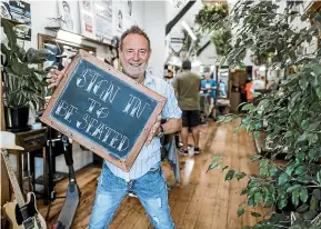  ?? ROSA WOODS/STUFF ?? Michael Petrie, director of Cuba Barbers, is enforcing a ‘‘no scan, no service’’ policy at his Wellington barbershop.