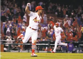  ?? Jeff Roberson / Associated Press ?? The Cardinals’ Randal Grichuk celebrates after his single in the bottom of the ninth inning drove home Jose Martinez (right) for the winning run.