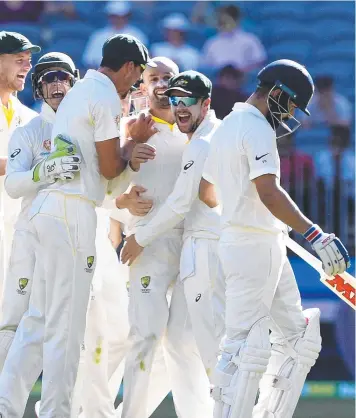  ??  ?? LAST LAUGH: Australian players celebrate the departure of Virat Kohli (right). Picture: AAP