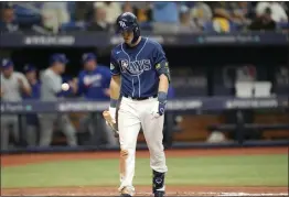  ?? PHOTOS BY JOHN RAOUX — THE ASSOCIATED PRESS ?? Tampa Bay Rays’ Curtis Mead heads back to the dugout after he struck out looking to end the game as the Texas Rangers beat the Rays 7-1 during Game 2 of an AL wild-card playoff series on Wednesday in St. Petersburg, Fla.