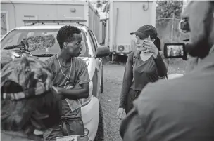  ?? FEDERICO RIOS/THE NEW YORK TIMES ?? Laura Loomer, a right-wing media activist, interviews Ayub, a Somalian migrant who is crossing the Darién Gap, at a Panama migrant reception center in February. The treacherou­s journey is drawing packs of American activists looking to distort how migration is perceived in the U.S.