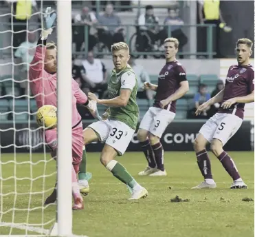  ??  ?? 0 Fraser Murray scores in the 87th minute to complete a comfortabl­e 3-0 win for Hibs at Easter Road.