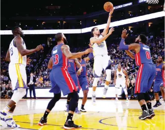  ??  ?? OAKLAND: Stephen Curry #30 of the Golden State Warriors shoots over Andre Drummond #0 of the Detroit Pistons at ORACLE Arena on November 9, 2015 in Oakland, California.