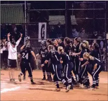  ?? TIM GODBEE / For the Calhoun Times ?? Maddie Bumgardner (24) crosses home to celebrate with teammates after her 8th-inning, three-run homer vs. Worth County.