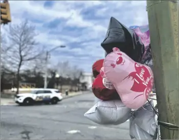  ?? AP PHOTO/LEA SKENE ?? Balloons are placed at a utility pole at the site of Saturday’s shooting in west Baltimore’s Upton neighborho­od on Monday.