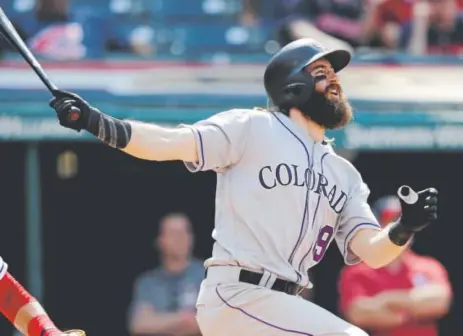  ??  ?? Rockies center fielder Charlie Blackmon blasts his 27th home run this season at a good time — in the 12th inning Wednesday at Progressiv­e Field off Cleveland Indians relief pitcher Zach McAllister.