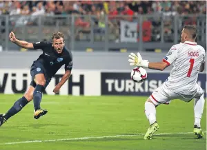  ??  ?? Harry Kane fires past Andrew Hogg for England’s fourth goal.