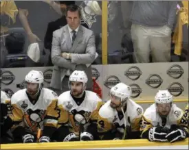  ?? MARK HUMPHREY — THE ASSOCIATED PRESS ?? Penguins coach Mike Sullivan watches along with his players during the final minutes of the third period in Game 4 of the Stanley Cup Finals against Nashville on June 5 in Nashville. The Predators won, 4-1, to tie the series 2-2.