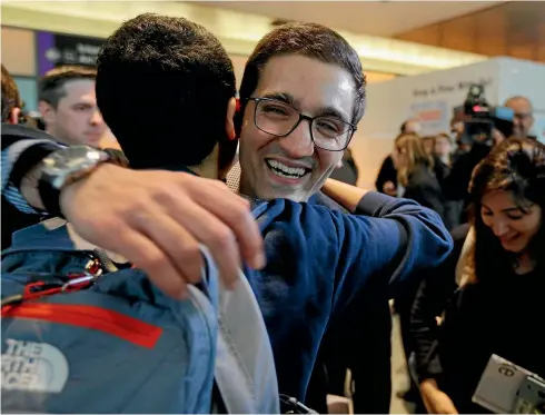  ?? REUTERS ?? Behnam Partopour, a student from Iran, is greeted by friends at Logan Airport in Boston yesterday. Partopour was originally turned away from a flight to the US following President Donald Trump’s executive order.