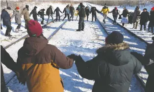  ?? DAVID BLOOM ?? Protesters perform a round dance as they end their blockade at the CN line near 231 Street and 110 Avenue on Wednesday. Rail disruption­s at various locations in Canada are into their second week.