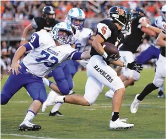  ??  ?? LaFayette's Dakota Cathey sprints past Trion's Nick McGhee. Cathey had an 87-yard kick return for a score, but it was not enough as the Ramblers dropped a 43-20 decision to the Bulldogs. (Catoosa News photo/Scott Herpst)