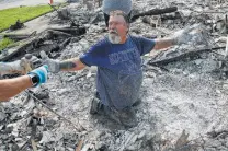  ?? John Locher / Associated Press ?? Tariffs hurt victims Rick Kincaid looks at a childhood toy that his wife found in the charred remains of their home in Redding, Calif. Theirs was one of more than 1,000 homes destroyed in the Carr Fire.