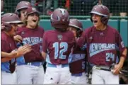  ?? GENE J. PUSKAR - THE ASSOCIATED PRESS ?? Fairfield, Conn.’s Troy Ashkinos (12) is greeted by teammates as he crosses home plate after hitting a grand slam off Jackson, N.J. pitcher Tai Mann in the fourth inning of an eliminatio­n baseball game in United States pool play at the Little League...