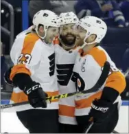  ?? CHRIS O’MEARA — THE ASSOCIATED PRESS ?? Flyers defenseman Brandon Manning (23) celebrates his goal against the Lightning with defenseman Radko Gudas (3) and center Claude Giroux (28) during the third period Friday in Tampa, Fla. The Flyers won 5-3.