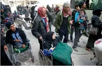  ?? Reuters ?? An elderly woman sits in a wheelchair during evacuation from the besieged town of Douma, Eastern Ghouta, on Thursday. —