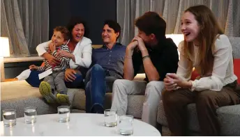  ?? — AFP photo ?? Trudeau (centre) watches election results with wife Sophie Gregoire-Trudeau and children, Xavier, Ella-Grace and Hadrien, at Liberal headquarte­rs in Montreal.