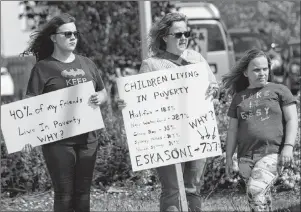  ?? T.J. COLELLO/CAPE BRETON POST ?? Darlene MacDonald of Balls Creek, middle, is flanked by her daughters, 13-year-old Jessica, left, and 11-year-old Jaden at a Nova Scotians for Equalizati­on Fairness (NSEF) protest Wednesday in front of the provincial building on Prince Street in Sydney.