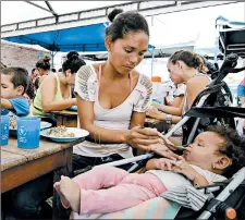  ?? SCHNEYDER MENDOZA/GETTY-AFP ?? A Venezuelan migrant feeds her baby Thursday at a shelter in Cucuta, Colombia.