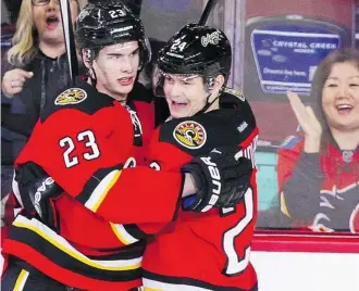  ?? Gavin Young/Calgary Herald ?? centre Sean Monahan, left, celebrates his goal with Jiri Hudler during NHL action at the Scotiabank Saddledome on New Year’s Eve. Calgary lost 4-1 to the Philadelph­ia Flyers.