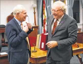  ?? MITCH MACDONALD/THE GUARDIAN ?? Green Leader Peter Bevan-Baker, left, and Premier Wade MacLauchla­n share a laugh and seasons greetings following the closure of the third session of the 65th General Assembly on Wednesday.