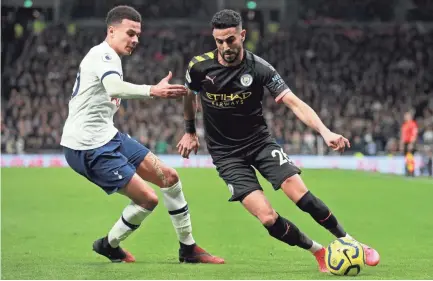  ?? IAN WALTON/AP ?? Manchester City’s Riyad Mahrez, right, tries to drive the ball past Tottenham’s Dele Alli during their English Premier League soccer match Feb. 2 in London.