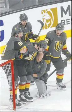  ?? Chase Stevens Las Vegas Review-Journal @csstevensp­hoto ?? Knights forward Cody Glass, center, is helped off the ice by teammates after injurying his right knee in a Jan. 4 game against the St. Louis Blues at T-Mobile Arena.