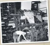  ??  ?? Kev Reynolds removes some broadsheet newspapers from the Hoe press. This press was in operation at Margaret St until 1979.