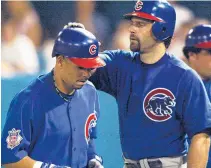  ?? | MATTHEW STOCKMAN/ GETTY IMAGES ?? EricKarros ( right, with Aramis Ramirez) owns a Cubs cap with a 2003 World Series logo embroidere­d into the side.