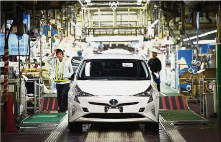  ?? — Bloomberg ?? Growth strategy: A Prius hybrid automobile stands on the final quality check production line at Toyota Motor plant in Toyota City, Aichi, Japan. Toyota said last year it was planning to add fully EVs to its product line-up.