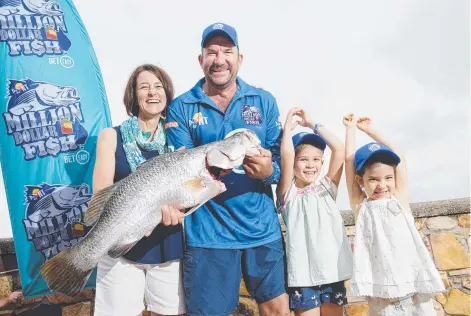  ?? Picture: MICHAEL FRANCHI ?? Fisho Mark Iseppi, with family Trish Iseppi, Faith Iseppi, and May Iseppi and the 86cm barramundi that won them $10,000 in the Northern Territory's Million Dollar Fish competitio­n