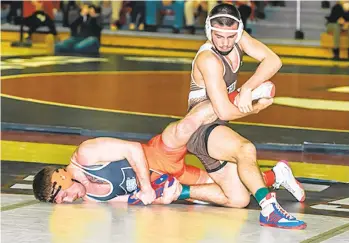  ?? LEHIGH UNIVERSITY ?? Lehigh’s Max Brignola, top, wrestles in the EIWA tournament last weekend. Brignola (18-6) is the No. 22 seed at 149 pounds in the NCAA championsh­ips.