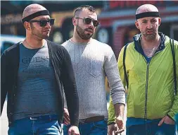  ??  ?? Patients walk on Taksim Square after a hair transplant surgery.