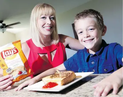  ?? JEAN LEVAC/OTTAWA CITIZEN ?? Angela Batley, with her son Will, is one of four finalists in Lay’s Do Us a Flavour Contest with her Grilled Cheese &amp; Ketchup chips.