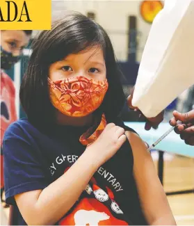  ?? MATT MILLS MCKNIGHT / REUTERS ?? Maya Griesemer, 7, receives a dose of the COVID-19 vaccine during a clinic at her school in Seattle, Wash. Canadian children are still awaiting approval for the vaccine.