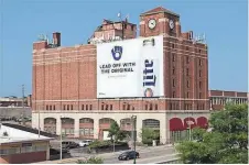  ?? WISCONSIN HISTORICAL SOCIETY ?? An eight-story warehouse overlookin­g Miller Valley and Miller Park has been sold to a Chicago investor, who will convert it into 1,000 self-storage units.