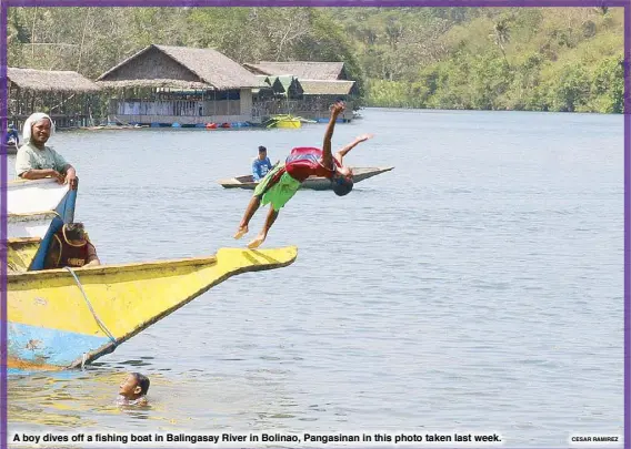  ?? CESAR RAMIREZ ?? A boy dives off a fishing boat in Balingasay River in Bolinao, Pangasinan in this photo taken last week.