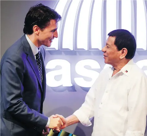  ?? MARK CRISTINO/ POOL PHOTO VIA THE ASSOCIATED PRESS ?? Prime Minister Justin Trudeau greets Philippine President Rodrigo Duterte at the Southeast Asian Nations Summit.