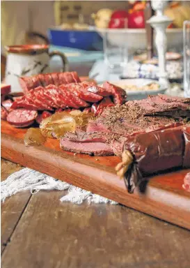  ??  ?? Chef Wade Truong, who took up hunting as an adult, creates a game charcuteri­e plate with, from left, venison summer sausage, beaver tail lardo, venison pastrami, venison andouille, and venison and pork country sausage.