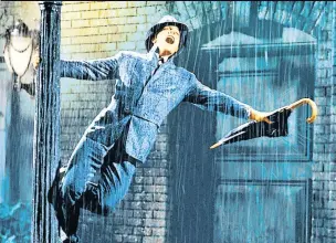  ??  ?? ICONIC Gene in the famous scene from the 1952 romantic musical film Singin’ in the Rain