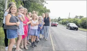  ??  ?? Parents and children on the busy Blackshaw Moor to Leek road.