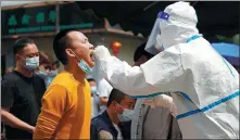  ?? JIANG LINGMENG / FOR CHINA DAILY ?? A medical worker conducts a nucleic acid test on a resident in Ruili, Yunnan province, on Wednesday. The city reported six locally transmitte­d, confirmed COVID-19 cases and three asymptomat­ic infections on Tuesday.