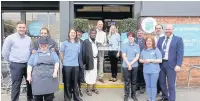  ??  ?? Alistair Kennedy and Jo Boyd from East Cheshire Hospice cut the ribbon to open the Co-op store in Ivy Road