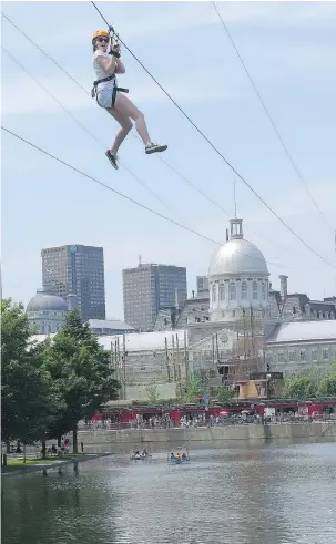  ?? — JIM BYERS FILES ?? For about $20, you can get a thrilling ride on the Montreal waterfront zip line with the city’s skyline in the background.