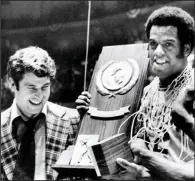  ?? (AP file photo) ?? Indiana’s Scott May (right) and Hoosiers Coach Bobby Knight celebrate with the championsh­ip trophy after defeating Michigan 86-68 at Philadelph­ia to win the 1976 national championsh­ip, finishing the season 32-0. Today, 45 years later, it remains the last perfect team in Division I men’s college basketball.