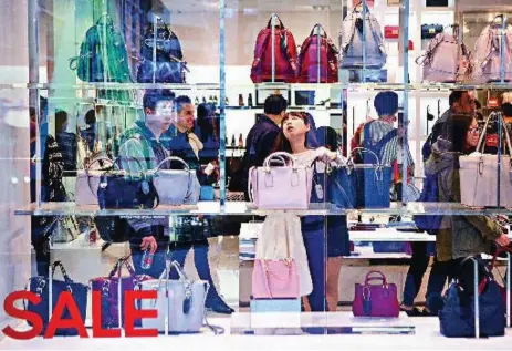  ?? CHRIS YOUNG/THE ASSOCIATED PRESS ?? Shoppers at the Eaton Centre last December seemed to prefer a more hands-on approach to shopping.