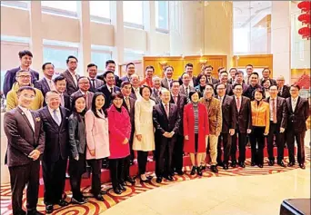  ?? PROVIDED TO CHINA DAILY ?? Wang Zhimin (center, front row), director of the Liaison Office of the Central People’s Government in the Hong Kong SAR, and members of the Legislativ­e Council share a group photo during a spring reception of the Liaison Office on Tuesday.